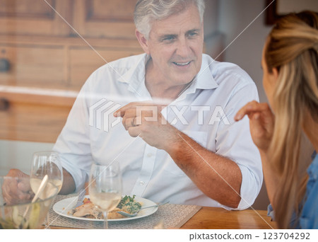 Food, family and father and daughter bonding at a table, talking and looking happy and cheerful. Love, nutrition and conversation by parent and woman relax and share meal in their home with wine Food, family and father and daughter bonding at a table, talking and looking happy and cheerful. Love, nutrition and conversation by parent and woman relax and share meal in their home with wine 123704292