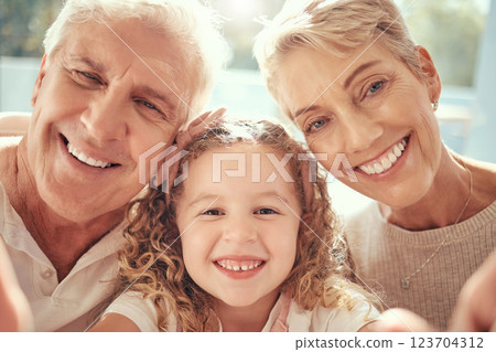 Phone selfie, grandparents and girl child family love to smile, happy and bonding together in support, care and happiness. Excited kid, retired senior grandma and grandfather take social media photo 123704312