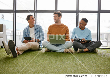 Laptop, tablet and businessmen in creative office working online for startup career. Work, business and digital technology in ecofriendly workplace. Team of men talking on floor in workspace 123704314