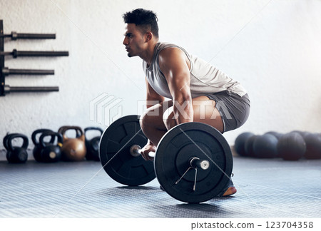 Workout, weightlifting and man doing deadlift training with strength, weights and motivation in fitness gym. Bodybuilder, sport and strong athlete doing power exercise with a dumbbell at health club 123704358