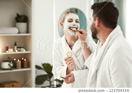 Happy couple playful, facial and relax at spa for wellness, skincare, love together and eating cucumber. Healthy fun relationship, luxury body care for calm, therapy and zen at health salon. 123704359