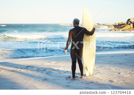 Surf, sport and sea with a man on the beach for fitness, exercise or workout during summer. Surfboard, training and health with a male surfer looking at the sea or ocean view while enjoying a holiday 123704418