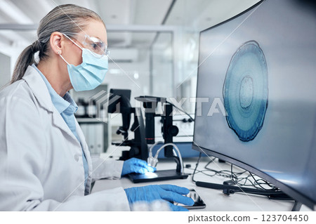 Scientist with computer screen, digital microscope and ppe analysis of bacteria for virus test, vaccine or research innovation and technology. Medical virus expert woman with pc monitor in laboratory Scientist with computer screen, digital microscope and ppe analysis of bacteria for virus test, vaccine or research innovation and technology. Medical virus expert woman with pc monitor in laboratory 123704450