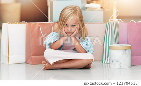 Bored child, fashion and shopping bags waiting on floor in kids clothing shop, store or boutique with cute girl sitting looking upset. Portrait of kid shopper or customer with sale purchase packages Bored child, fashion and shopping bags waiting on floor in kids clothing shop, store or boutique with cute girl sitting looking upset. Portrait of kid shopper or customer with sale purchase packages 123704515