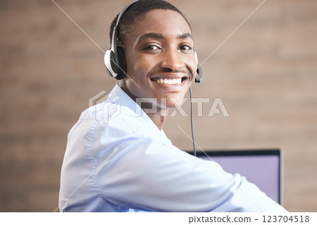 Contact us customer support and black man web help worker on an office internet consultation. Portrait of a happy call center telemarketing consultant employee working on a digital crm consulting Contact us customer support and black man web help worker on an office internet consultation. Portrait of a happy call center telemarketing consultant employee working on a digital crm consulting 123704518