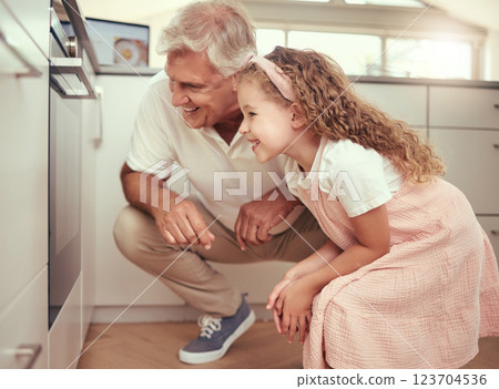 Grandfather and girl child in kitchen cooking oven food together and excited for results. Happy family, learning and love from elderly senior man with kid baking for happy holiday home celebration Grandfather and girl child in kitchen cooking oven food together and excited for results. Happy family, learning and love from elderly senior man with kid baking for happy holiday home celebration 123704536
