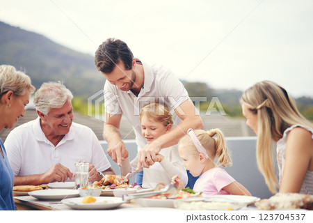 Thanksgiving lunch, big family and dad turkey carving outdoor with food and happy people. Father, senior grandparents and children with a happiness smile on a balcony table ready to eat with the kids 123704537