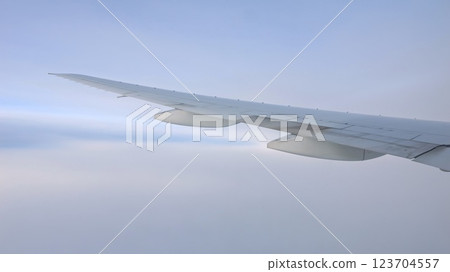 Airplane wing soaring through the sky 123704557