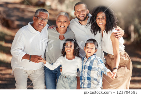 Black family in a park portrait for summer holiday, outdoor wellness and growth development with elderly grandparents and children. African grandmother, grandfather with dad, mom and kids lens flare 123704585