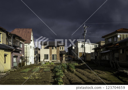 Japanese houses with vegetable gardens, under stormy clouds Kanazawa, Japan Japanese houses with vegetable gardens, under stormy clouds Kanazawa, Japan 123704659