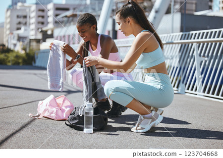 Fitness, women and city friends in street before run on summer morning. Diversity, urban exercise and girl time before workout. Woman and friend getting ready for outdoor training, gym bag and water. Fitness, women and city friends in street before run on summer morning. Diversity, urban exercise and girl time before workout. Woman and friend getting ready for outdoor training, gym bag and water. 123704668