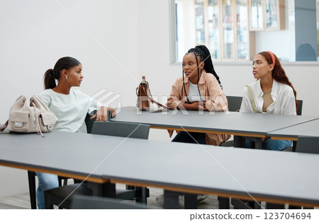 Student friends and talk in university cafeteria for course guidance and thoughts in break. Young and diverse women in friendship at education facility discuss lecture study group plan. 123704694