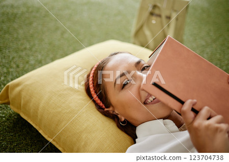 Study, education and relax student woman on pillow with book for planning, reading work and university course planner. Happy portrait of college girl with notes studying for exam or learning test Study, education and relax student woman on pillow with book for planning, reading work and university course planner. Happy portrait of college girl with notes studying for exam or learning test 123704738