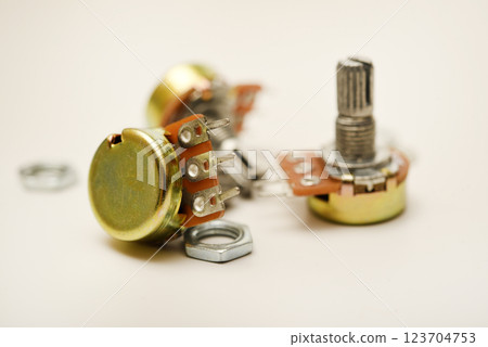 A potentiometer with fasteners. Variable resistor. A resistor with a rotator. 123704753