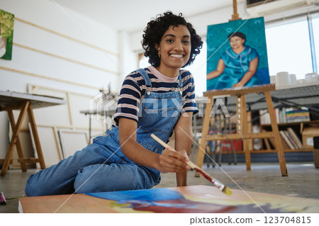 Woman, painter and art in creative workshop with happy smile for freelance in colorful arts and talent. Portrait of a freelancer female artist painting on a canvas smiling in studio for creativity 123704815