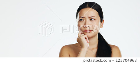 Skincare, thinking and Asian woman in a studio with a beauty, self care and natural routine. Question, doubtful and portrait of a female model with dermatology facial treatment by white background. 123704968