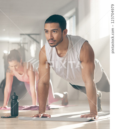 Athlete, man and push up for fitness at gym with exercise, core strength and body balance. Male person, plank and muscle training for endurance, cardio performance and sports workout of wellness goal Athlete, man and push up for fitness at gym with exercise, core strength and body balance. Male person, plank and muscle training for endurance, cardio performance and sports workout of wellness goal 123704979