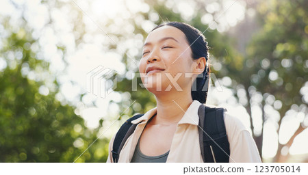 Thinking, hiking and Asian woman with nature, travel and contemplating with adventure. Japanese person, outdoor and calm hiker with hobby, breathing and carefree in forest, journey and mindfulness 123705014