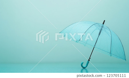 Transparent light blue umbrella standing on reflective surface with turquoise background Transparent light blue umbrella standing on reflective surface with turquoise background 123705111
