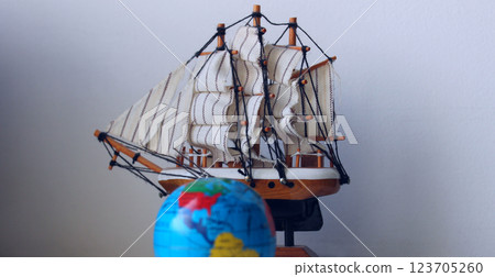 Travel Concept Stock Photo. Blurred Globe In Front Of Wooden Model Of Old Ship Travel Concept Stock Photo. Blurred Globe In Front Of Wooden Model Of Old Ship 123705260