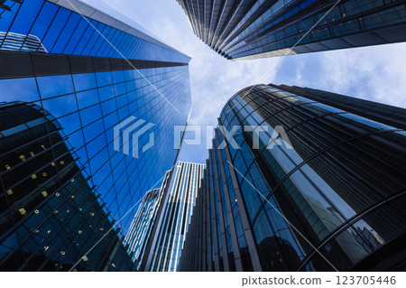 Futuristic cityscape with towering skyscrapers and reflective glass facades Futuristic cityscape with towering skyscrapers and reflective glass facades 123705446