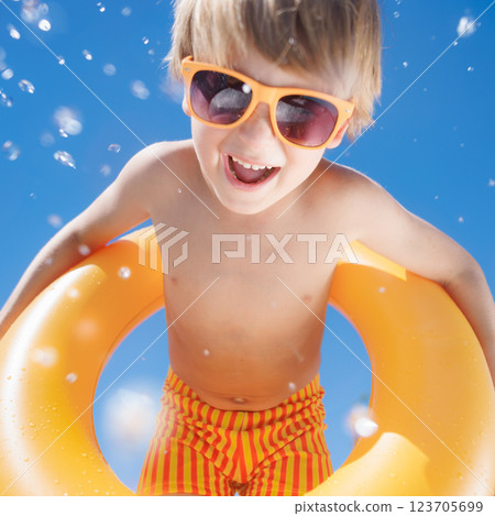 Happy child playing in waterpark. Kid having fun on summer vacation 123705699