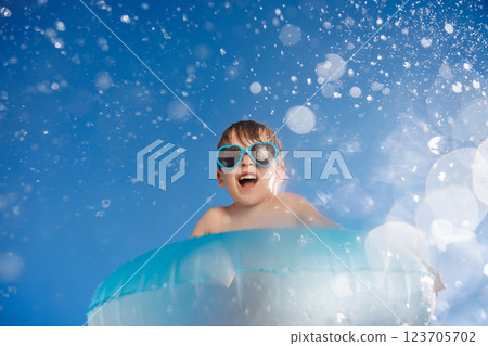Happy child playing in waterpark. Kid having fun on summer vacation 123705702