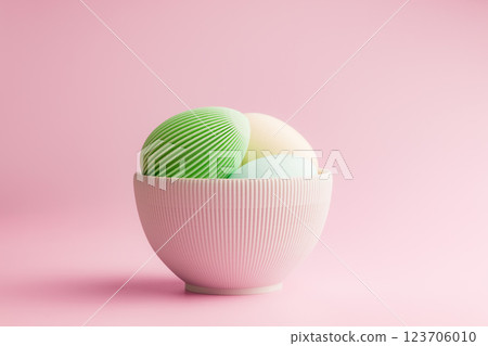 Easter decoration. Colorful eggs in bowl on pink background. 123706010