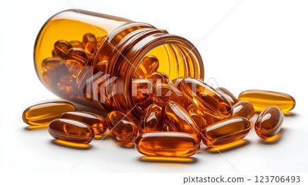 Golden omega-3 capsules spill from amber bottle on a clean white background 123706493