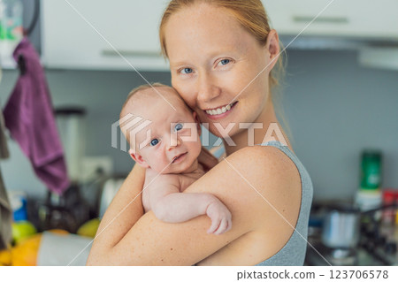 A mother lovingly embraces her newborn baby, holding them close to her chest. A tender moment of warmth, security, and deep maternal love, symbolizing bonding, comfort, and the unbreakable connection 123706578