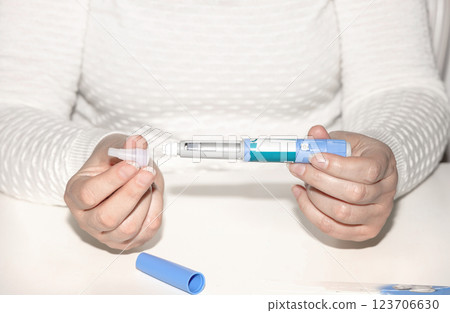 Female hands holding an insulin pen. Ozempic Insulin injection pen. 123706630