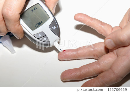Diabetic man measuring blood sugar level. Blood test for diabetes. Diabetic man measuring blood sugar level. Blood test for diabetes. 123706639