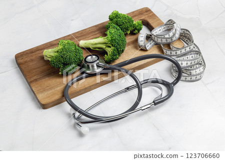 Concept of healthy eating and weight loss. Broccoli on a cutting board. 123706660