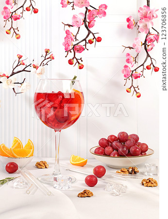 Royal lemonade cocktail with tequila, gin, rum, ice and grapes, bar and party concept, restaurant and cafe advertising card, elegant background with spring sakura flowers, selective focus. 123706856