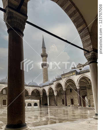 Courtyard View of Historic Minaret and Architectural Arches Under Overcast Sky, Istanbul, Turkey Courtyard View of Historic Minaret and Architectural Arches Under Overcast Sky, Istanbul, Turkey 123707008