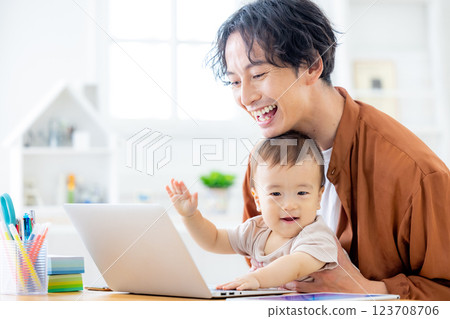 A man who works at home while taking care of his baby 123708706