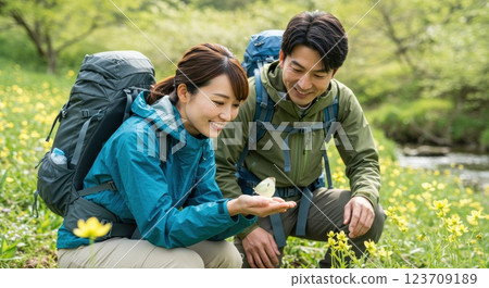Men and women enjoying a spring hike with butterflies and flowers 123709189