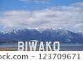 A view of Lake Biwa with a monument overlooking Mount Hiei 123709671