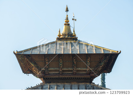 A bunk roof and a golden spire on main temple of Pashupatinath in Kathmandu, Nepal. This temple is a Hindu temple dedicated to Pashupati, a form of Shiva. A bunk roof and a golden spire on main temple of Pashupatinath in Kathmandu, Nepal. This temple is a Hindu temple dedicated to Pashupati, a form of Shiva. 123709923
