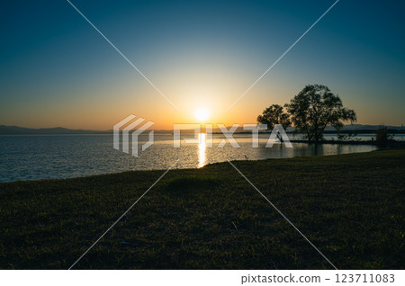 Sun setting over the lake 123711083