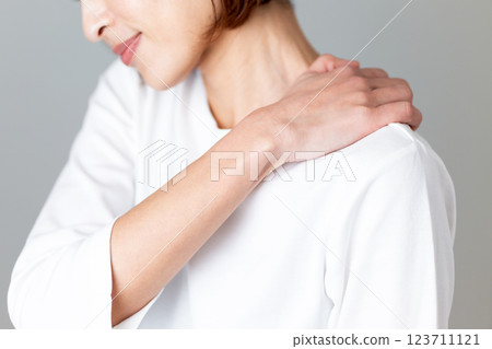 Middle-aged woman suffering from stiff shoulders Middle-aged woman suffering from stiff shoulders 123711121