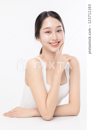 Close up facial of young Asian beautiful woman with K-beauty make up style and healthy and perfect glow skin with copyspace isolated on white background for skincare commercial product advertising. 123711163