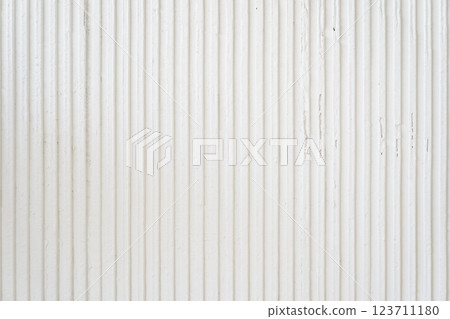 A white wavy wall with a copy space for your design. Decorative plaster on the wall. Uneven wall surface. High quality photo 123711180