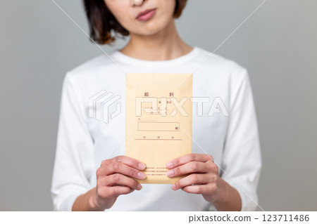A middle-aged woman worried about her pay packet 123711486