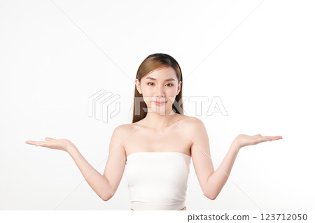 A beautiful young Asian woman with clean, fresh skin against a white background. She represents beauty, skincare, and spa treatments. A beautiful young Asian woman with clean, fresh skin against a white background. She represents beauty, skincare, and spa treatments. 123712050