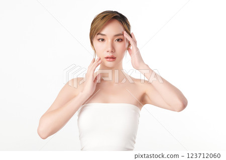 A beautiful young Asian woman with clean, fresh skin against a white background. She represents beauty, skincare, and spa treatments. A beautiful young Asian woman with clean, fresh skin against a white background. She represents beauty, skincare, and spa treatments. 123712060