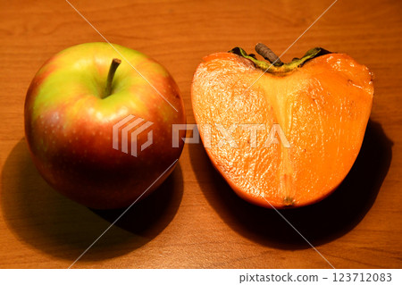 Healthy food. Top view of sliced ingredients for fruit salad or snack - apple, pear, nuts, persimmon. Flat lay, copy on wood Healthy food. Top view of sliced ingredients for fruit salad or snack - apple, pear, nuts, persimmon. Flat lay, copy on wood 123712083