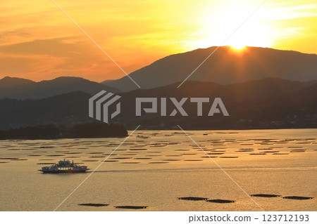 A ferry passing between oyster rafts in Mitsu Bay (Higashihiroshima City) A ferry passing between oyster rafts in Mitsu Bay (Higashihiroshima City) 123712193