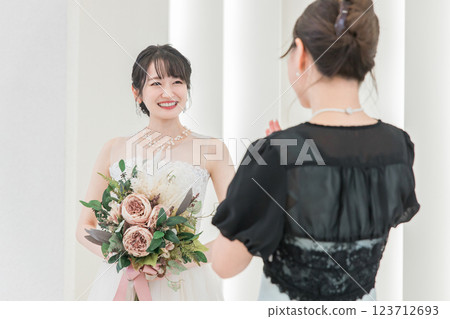 A bride and a guest, friend, relative woman talking at a wedding reception 123712693