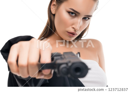 Confident woman aims a gun directly at the camera in a striking pose 123712837